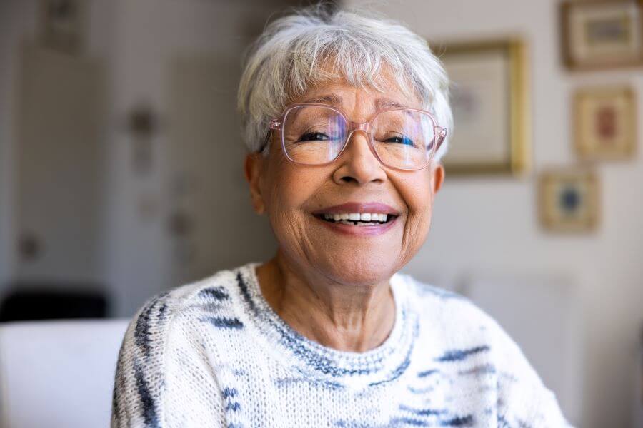 A senior woman smiling in her home