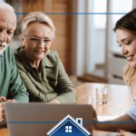 woman showing an elderly couple something on a laptop