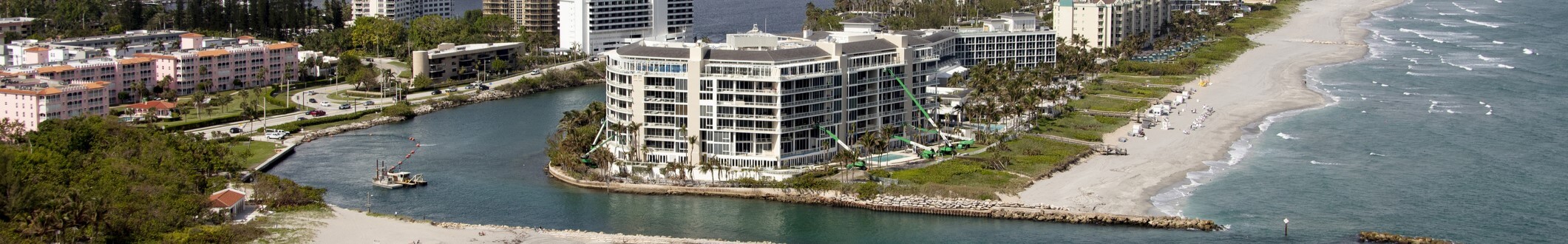 an aerial view of a beach with a large building in Florida